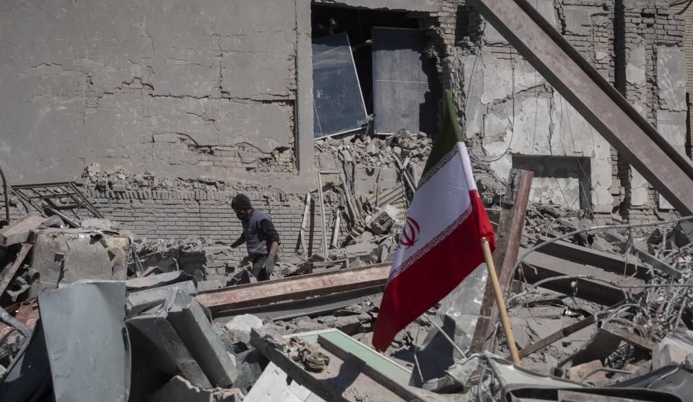 An unidentified man works among the ruins of a police station that is struck during U.S.-Israeli attacks in Tehran, Iran, on March 3, 2026. (Photo by Morteza Nikoubazl/NurPhoto) (Photo by Morteza Nikoubazl / NurPhoto via AFP)