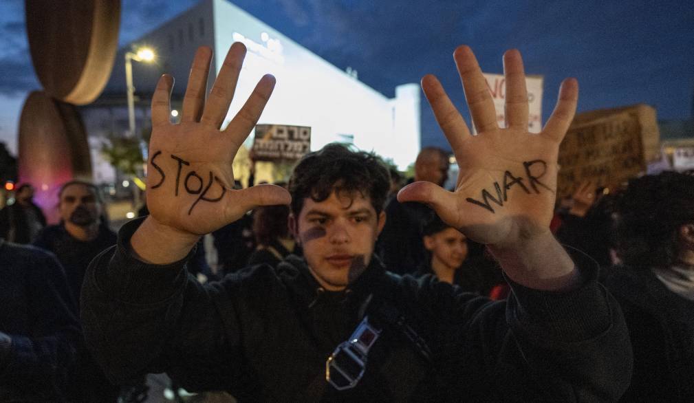 TEL AVIV, ISRAEL - MARCH 07: People protest the US-Israeli attacks on Iran, carrying banners that read 'Justice for Gaza' and 'Stop the war' in Tel Aviv, Israel on March 07, 2026