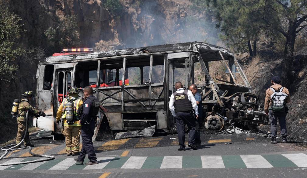 Firefighters and members of the Morelia police work at the scene where a vehicle is set on fire by suspected members of organized crime after the killing of Nemesio Oseguera Cervantes, known as El Mencho, leader of the Jalisco New Generation Cartel, in Morelia, Mexico, 22 February 2026