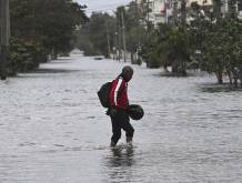 A man wades through a flooded street in Havana after the arrival of a cold front on February 1, 2026