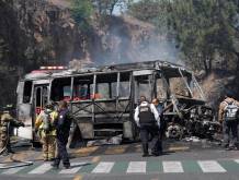 Firefighters and members of the Morelia police work at the scene where a vehicle is set on fire by suspected members of organized crime after the killing of Nemesio Oseguera Cervantes, known as El Mencho, leader of the Jalisco New Generation Cartel, in Morelia, Mexico, 22 February 2026