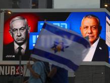 epa13328210 People walk in front of an election campaign billboard featuring Israeli Prime Minister Benjamin Netanyahu (L) and the leader of the Yashar party, Gadi Eisenkot (R), reading 'The battle is closed!' in Tel Aviv, Israel, 24 October 2026. Israel will hold its national legislative election to choose the 120 members of the 26th Knesset on 27 October 2026. EPA/ABIR SULTAN