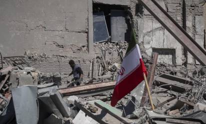 An unidentified man works among the ruins of a police station that is struck during U.S.-Israeli attacks in Tehran, Iran, on March 3, 2026. (Photo by Morteza Nikoubazl/NurPhoto) (Photo by Morteza Nikoubazl / NurPhoto via AFP)