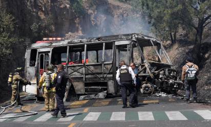 Firefighters and members of the Morelia police work at the scene where a vehicle is set on fire by suspected members of organized crime after the killing of Nemesio Oseguera Cervantes, known as El Mencho, leader of the Jalisco New Generation Cartel, in Morelia, Mexico, 22 February 2026