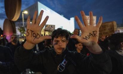 TEL AVIV, ISRAEL - MARCH 07: People protest the US-Israeli attacks on Iran, carrying banners that read 'Justice for Gaza' and 'Stop the war' in Tel Aviv, Israel on March 07, 2026