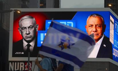 epa13328210 People walk in front of an election campaign billboard featuring Israeli Prime Minister Benjamin Netanyahu (L) and the leader of the Yashar party, Gadi Eisenkot (R), reading 'The battle is closed!' in Tel Aviv, Israel, 24 October 2026. Israel will hold its national legislative election to choose the 120 members of the 26th Knesset on 27 October 2026. EPA/ABIR SULTAN